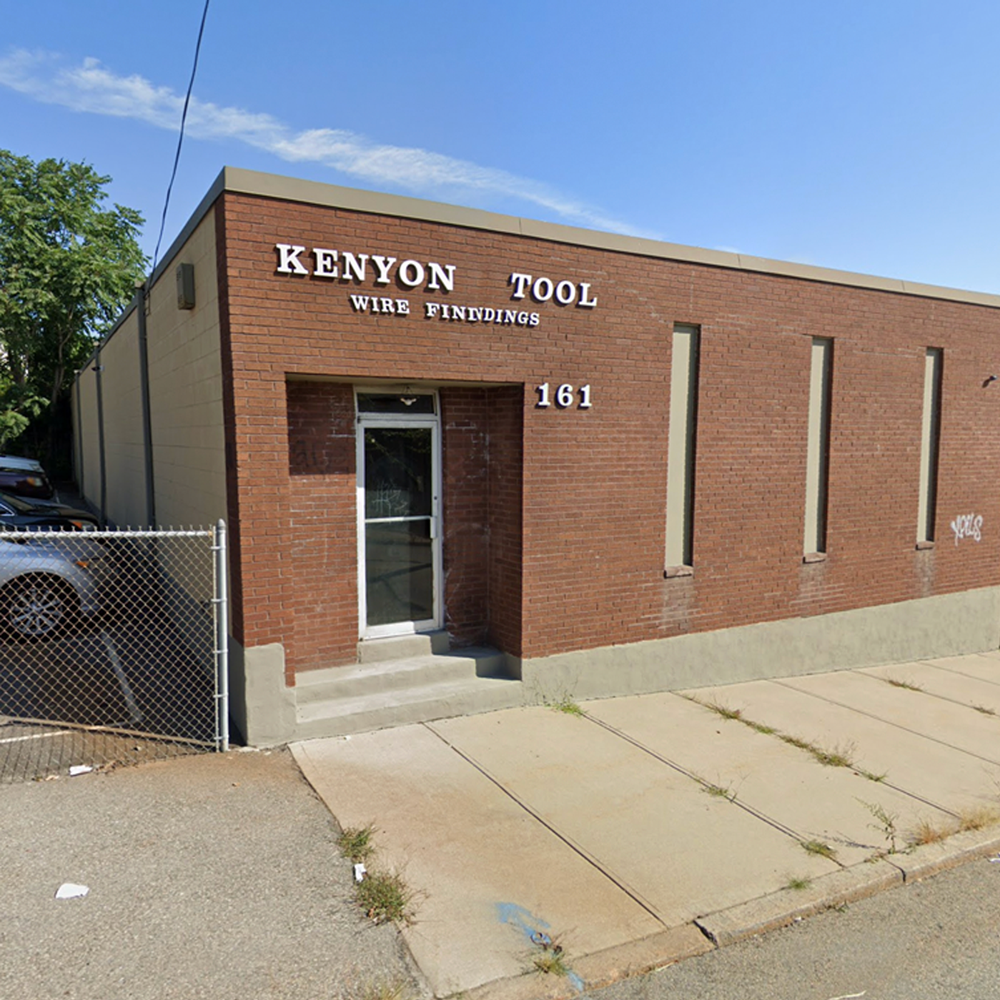 Brick building with Kenyon Tool in white letters on the side